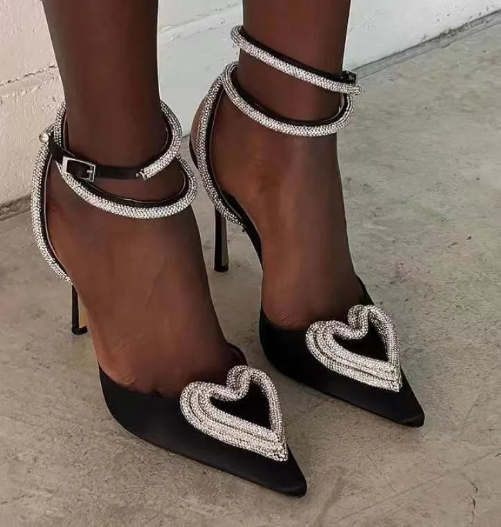Women's pink satin sandal with heart-shaped rhinestone detail and pointed toe holder on a rubber sole.