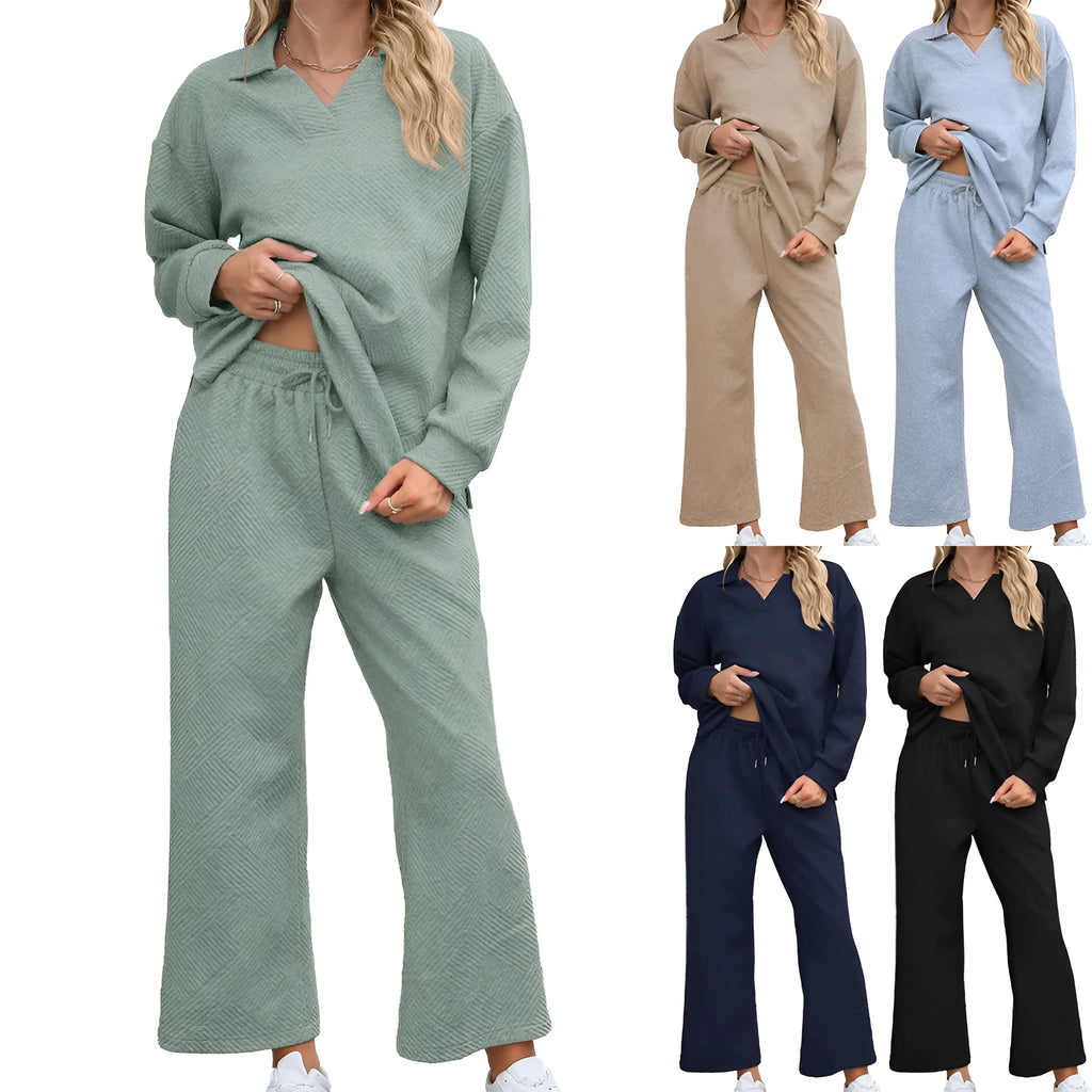 Women's black knitted jacquard long sleeve sweater and elastic waist cropped pants suit on a hanger.