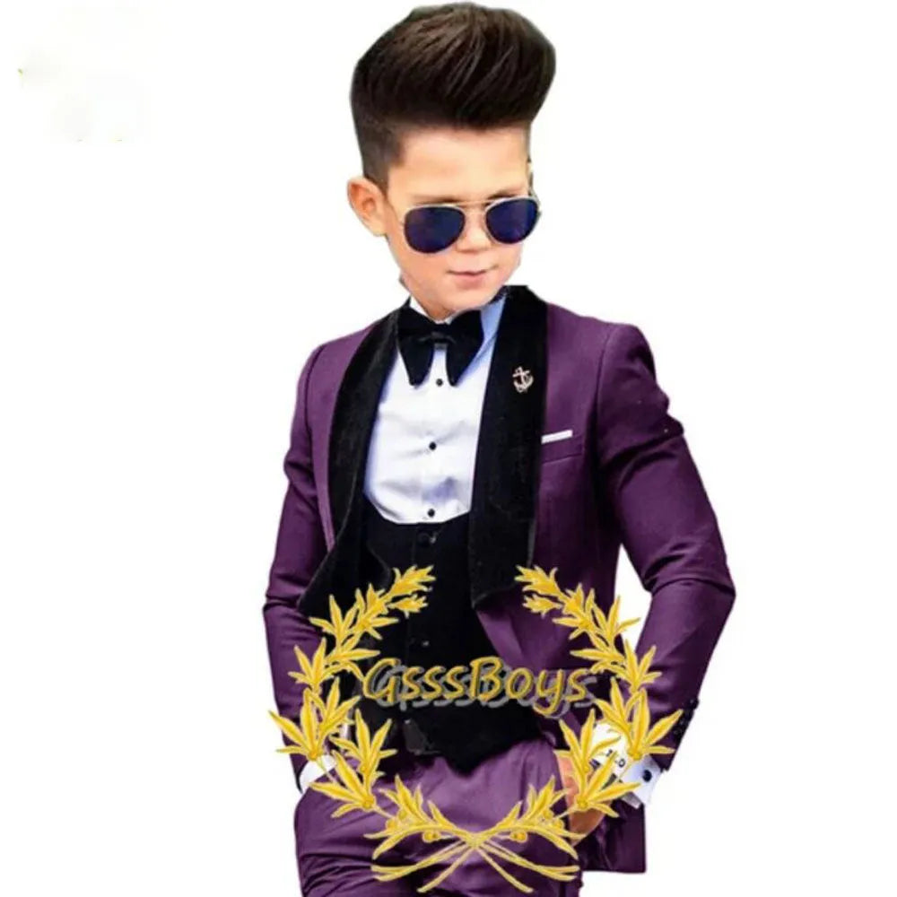 Boys' three-piece suit set in polyester fibre, including jacket, vest, and trousers, available in multiple colours and sizes from 3T to 16T.