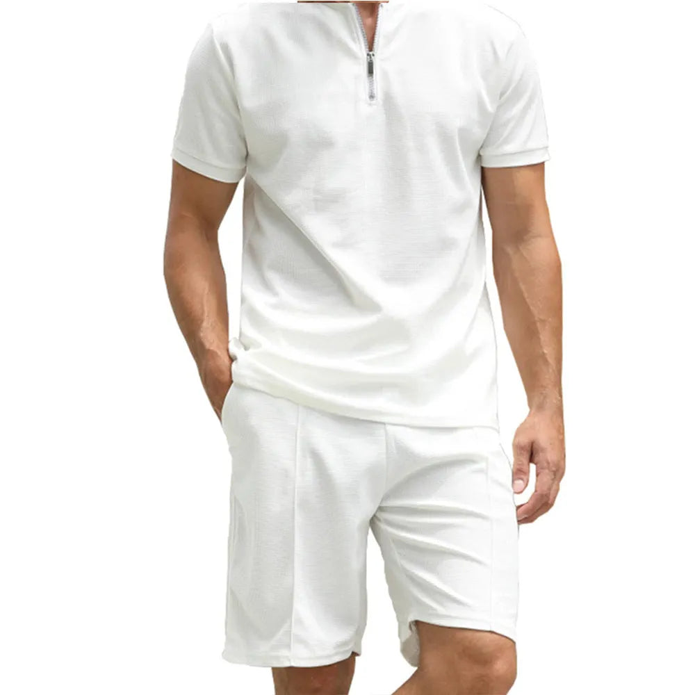 Men's solid colour polo shirt and matching trousers two-piece suit set on a hanger.