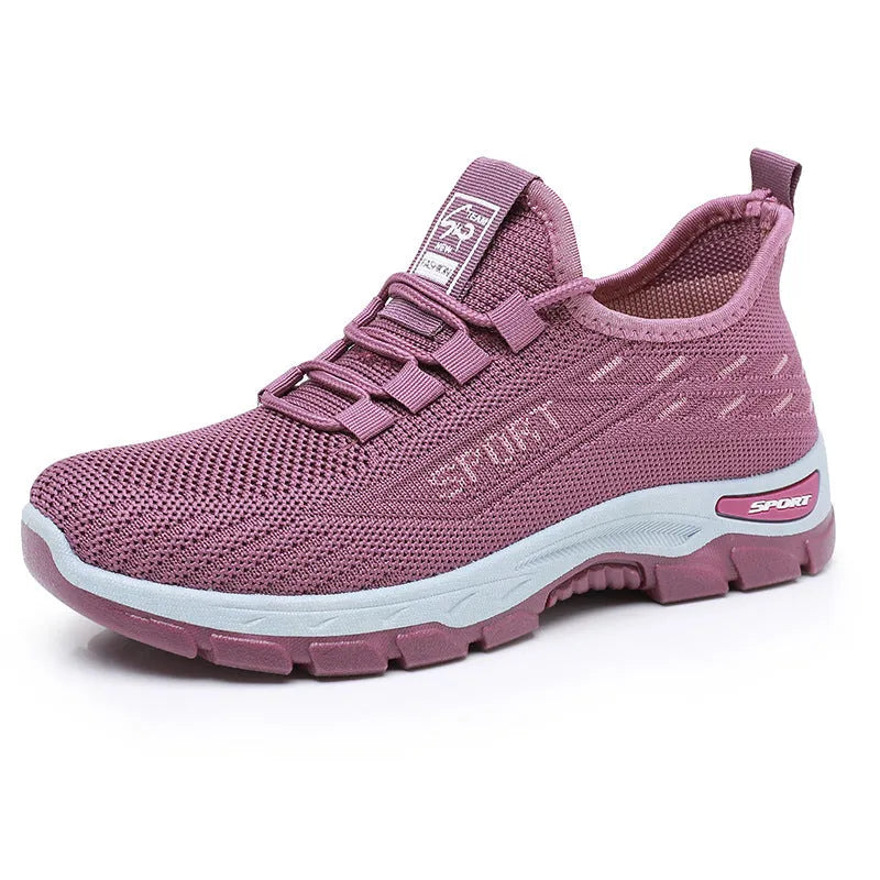 Men's and women's low-top casual sneakers with soft PVC sole in black, brown, grey, light purple, and red.