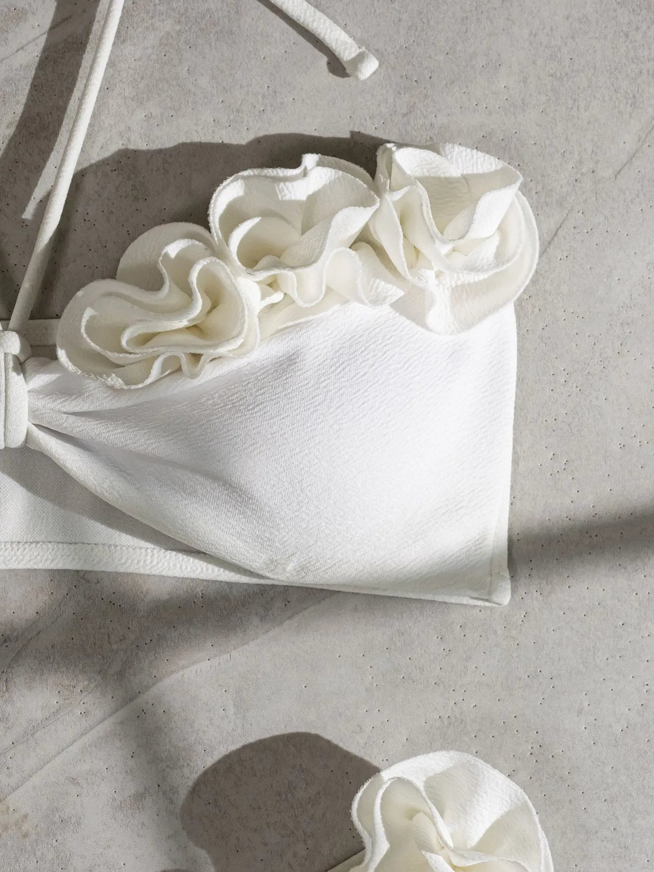 White women's swimsuit with 3D floral pattern, halter neck, and lace-up back.