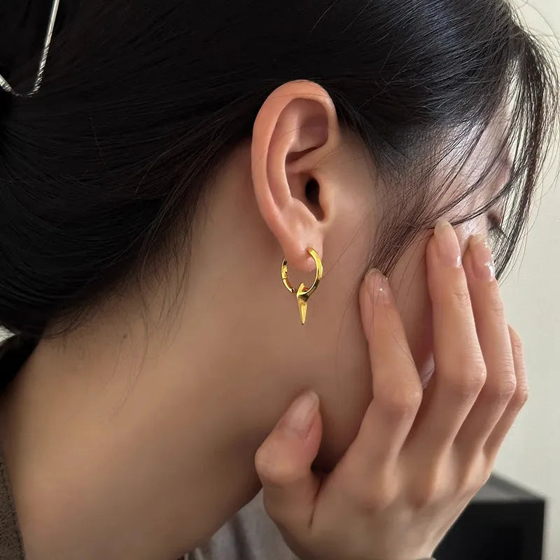 Women's geometric star-shaped clip earrings with a platinum electroplated finish on copper.