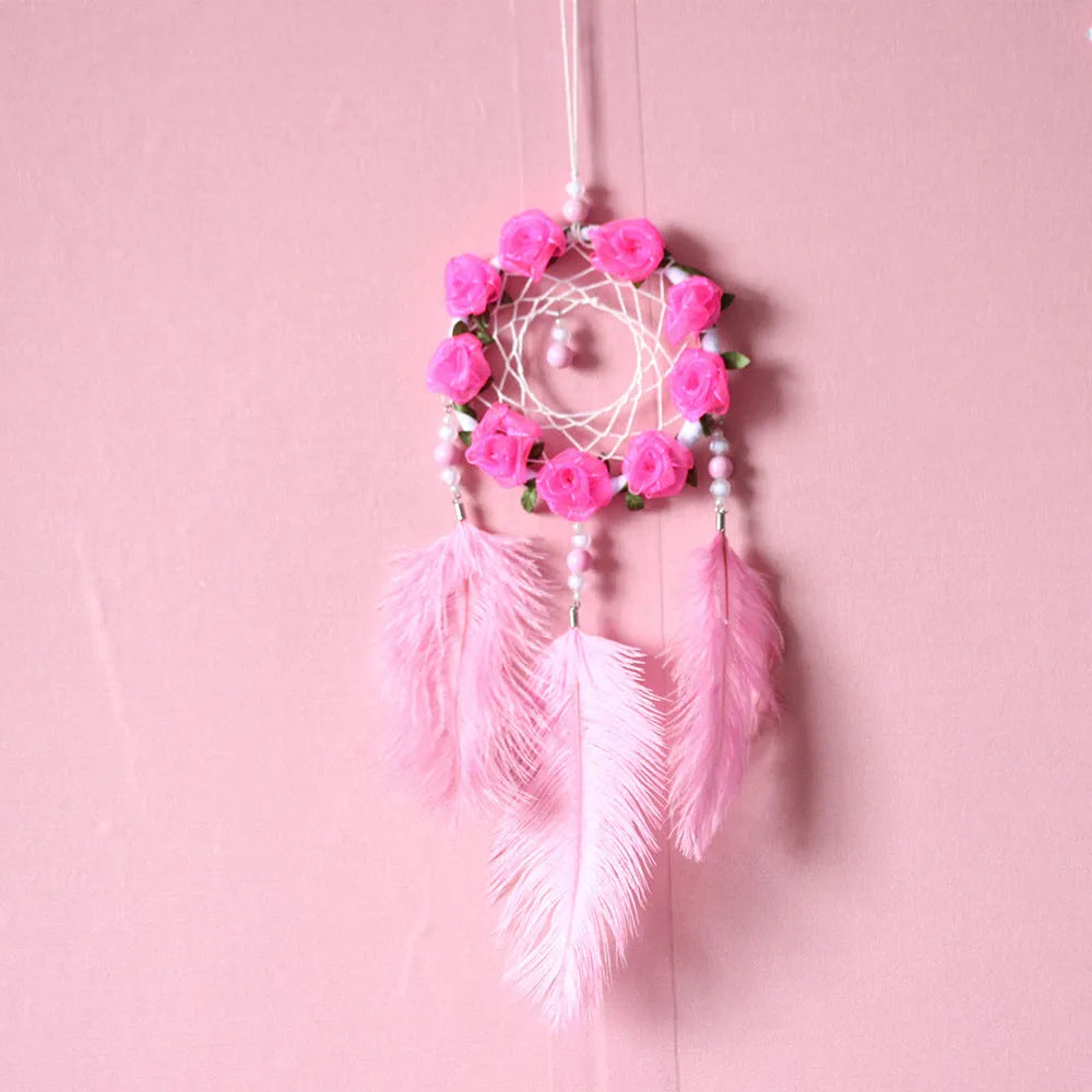 Close-up of a modern pink ostrich feather dreamcatcher wind chime wall ornament.