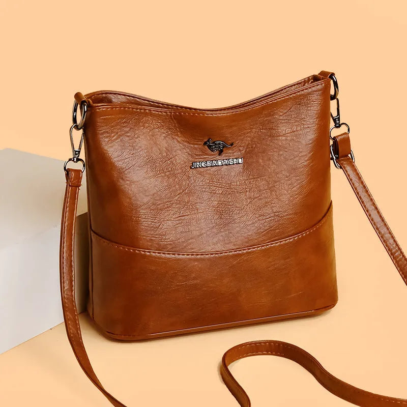 Women's soft leather bucket shoulder bag in black with sewing line detailing and mobile phone pocket