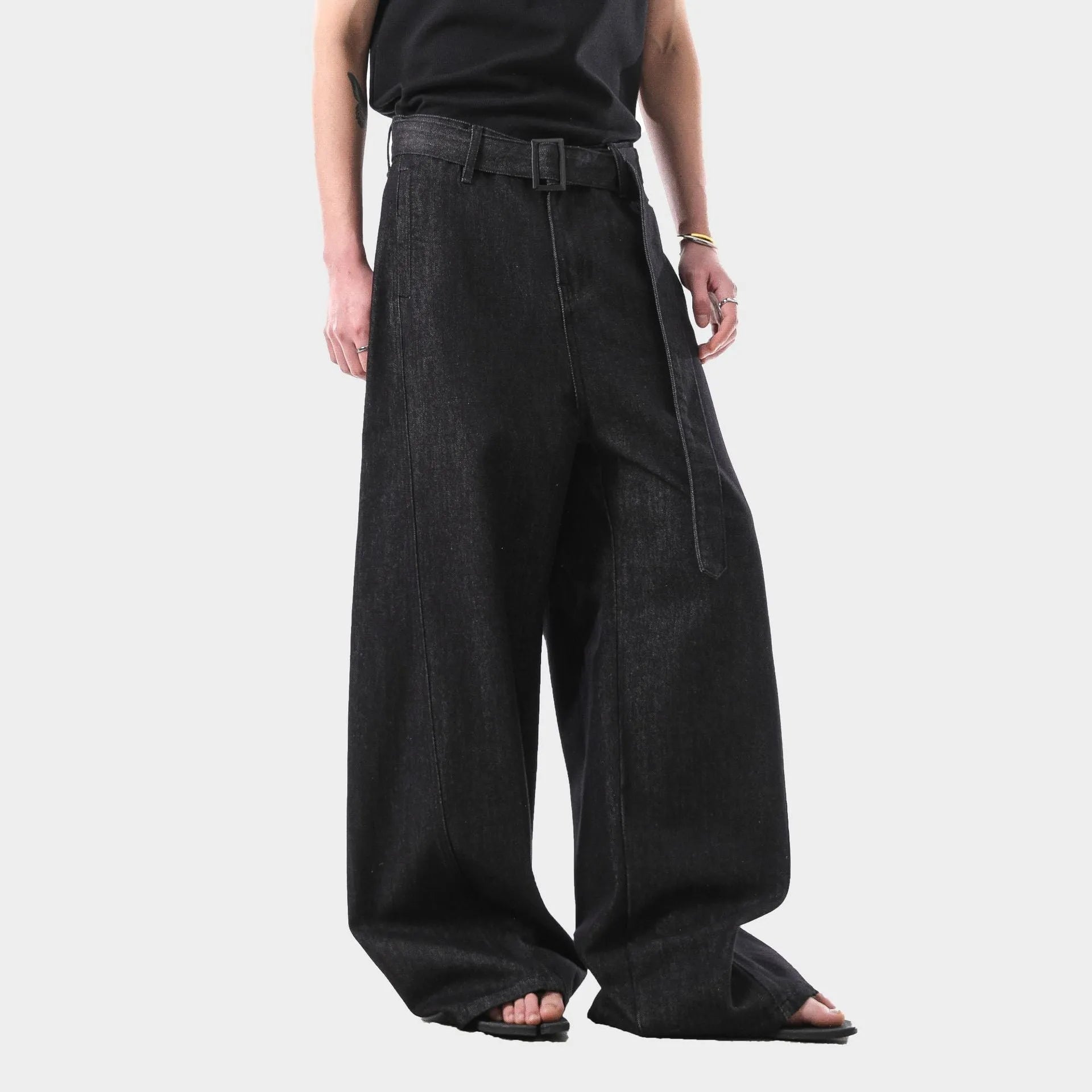 Black high waist straight leg jeans with gold details on a model.