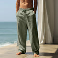 Men's loose fit casual cotton trousers in a solid colour, shown in one of seven available colours.
