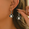 A pair of silver retro fashion earrings for women with a creative design and alloy construction.