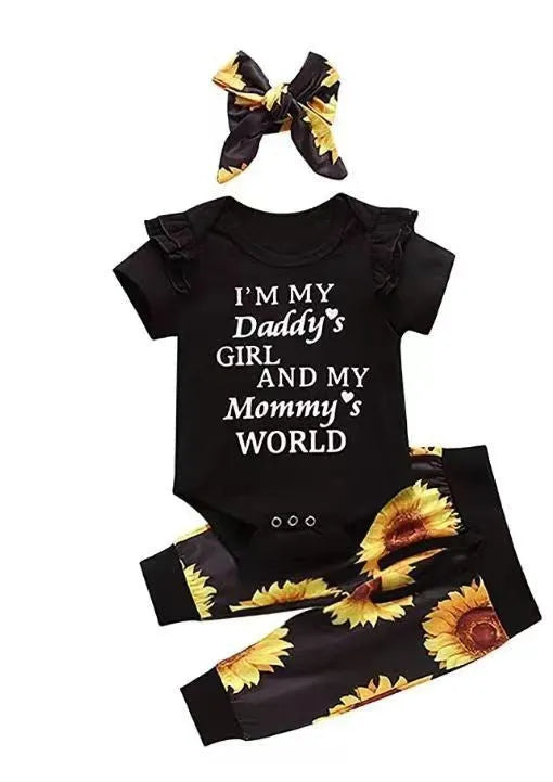 Baby jumpsuit set with cotton top, pants, and matching headband in black letter print