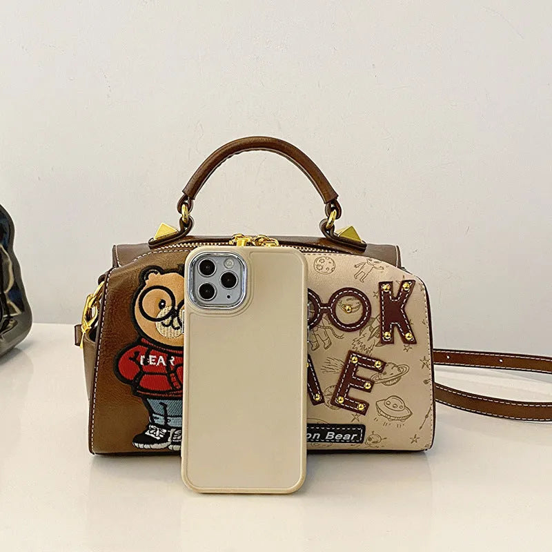 Brown PU handbag with printed cartoon design, horizontal square shape, and single shoulder strap