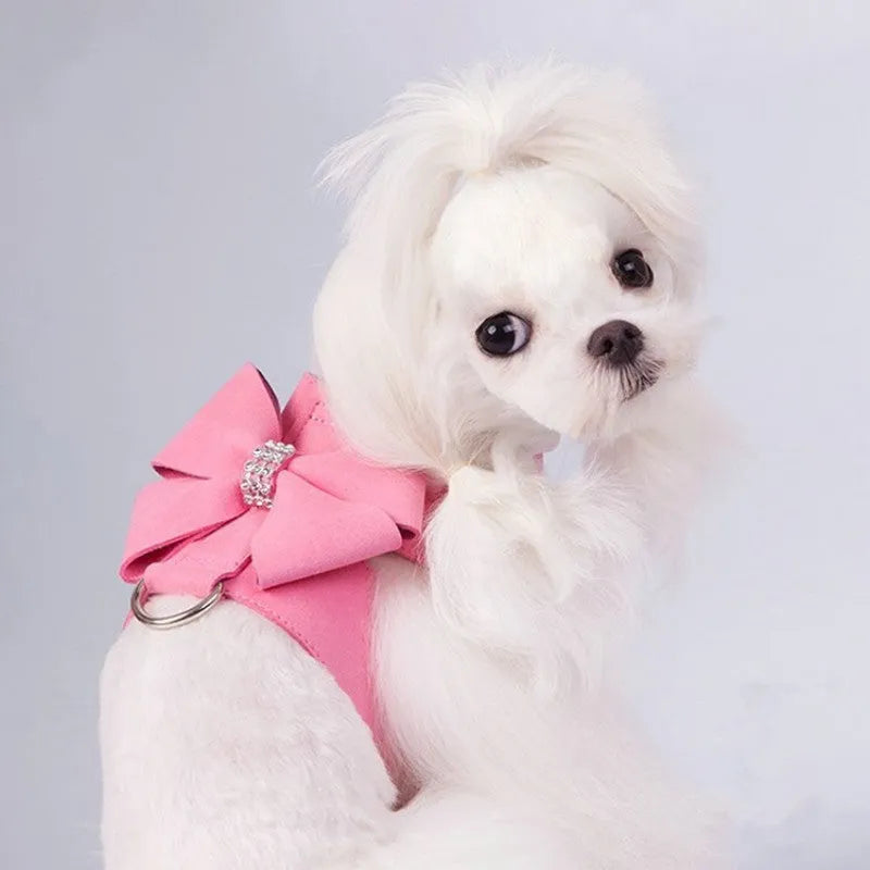 A pink microfiber dog harness with a decorative bowknot on the collar, sized for a small puppy.