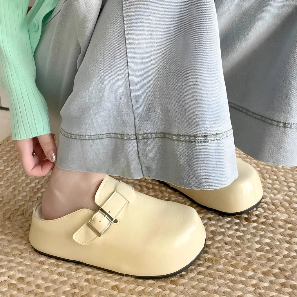 Flat buckle casual slippers with round toe and PU upper in beige colour on a clean surface