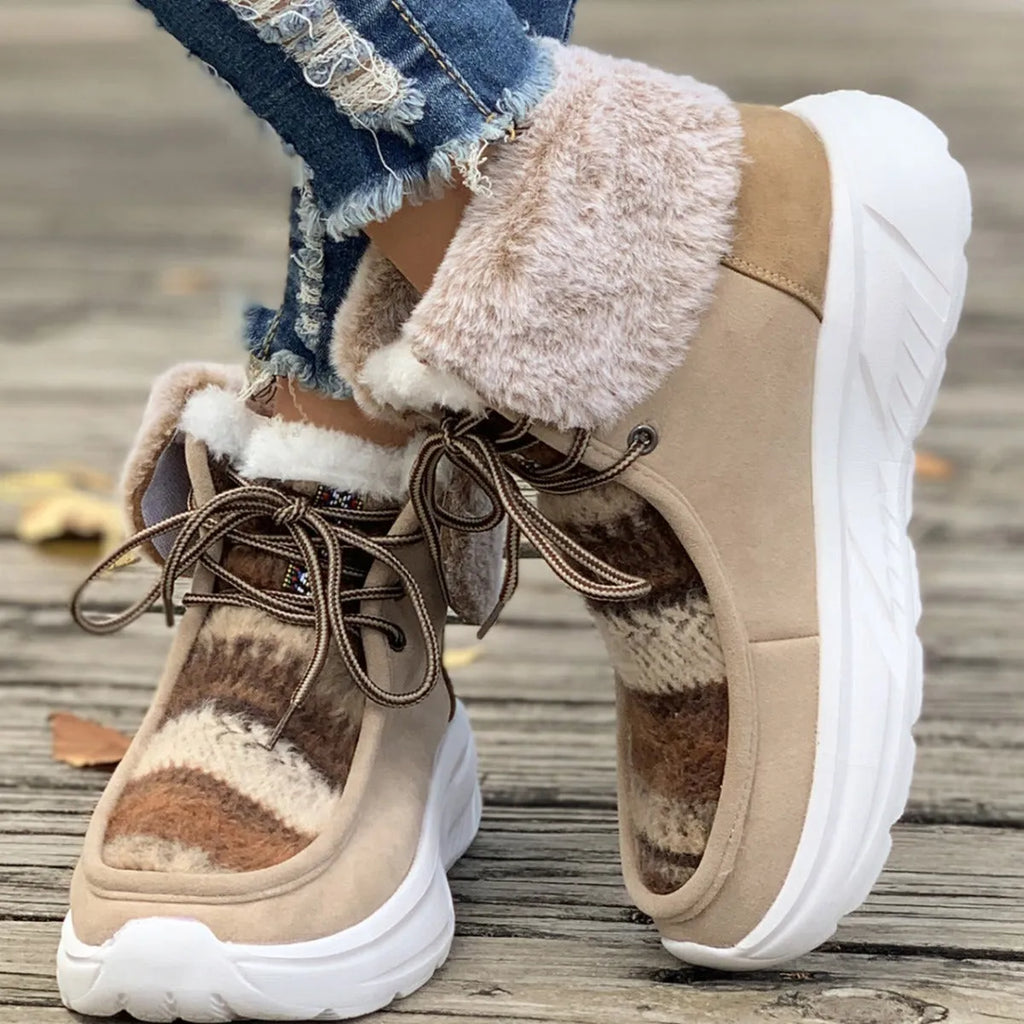 Beige women's lace-up suede snow boots with a thick platform sole and fur lining.