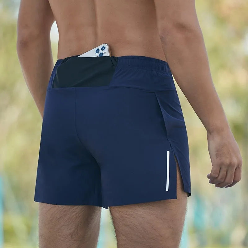 Men's loose fit off-road running shorts in black, shown from front, highlighting high waistband and athletic cut.
