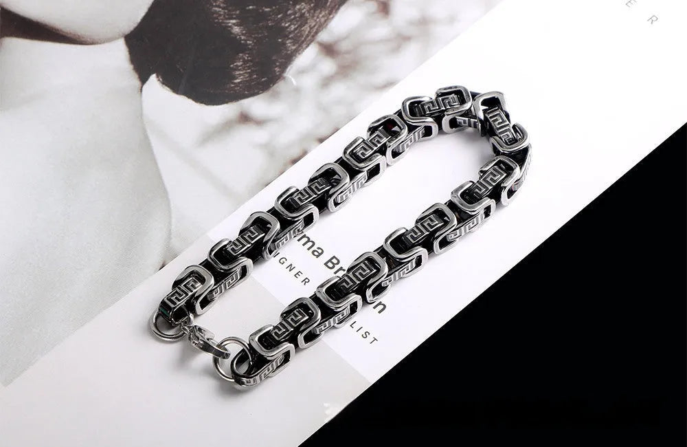 Retro black polished stainless steel geometric chain bracelet on a neutral surface
