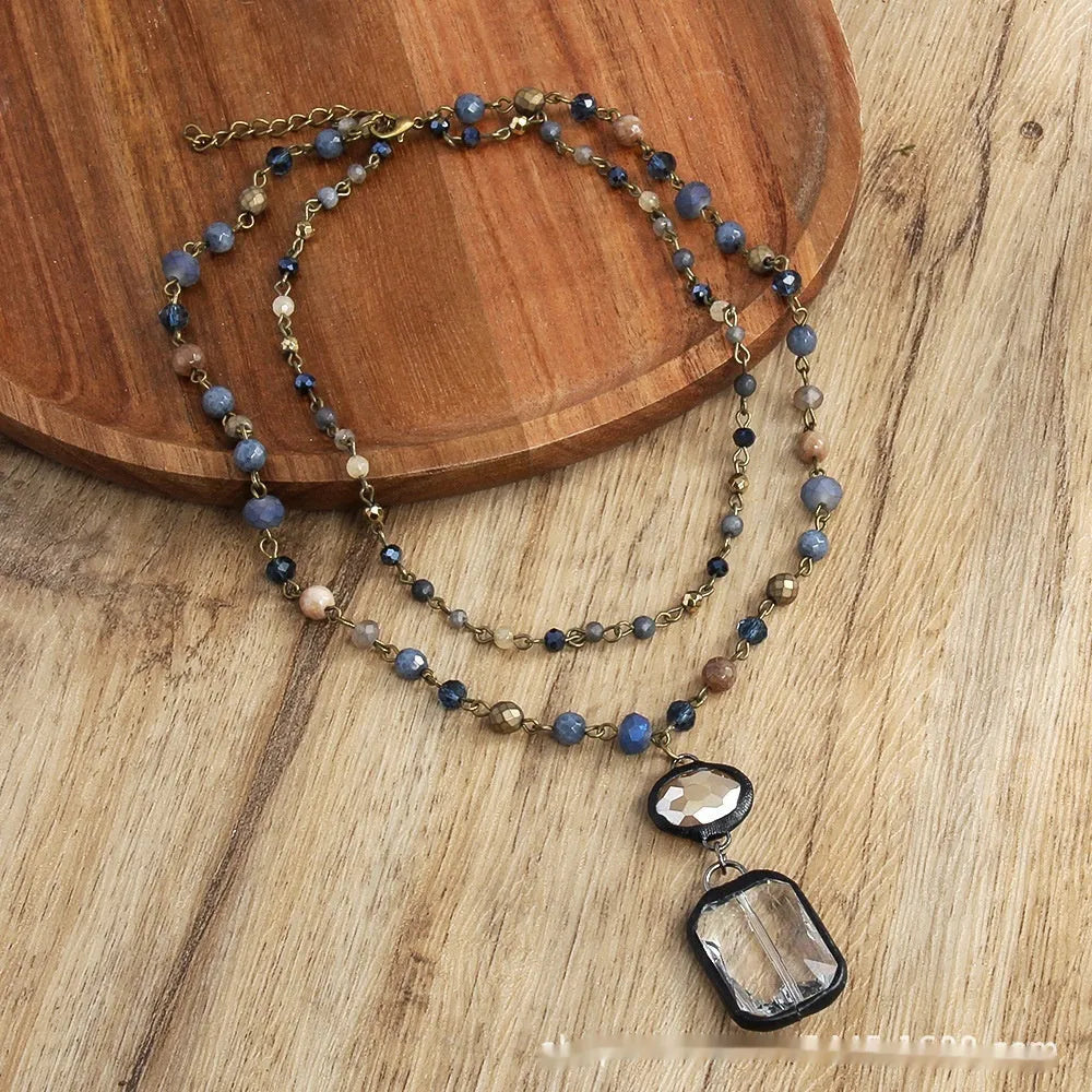 Two-layer tribal necklace with glass pendant and natural stone elements on adjustable chain