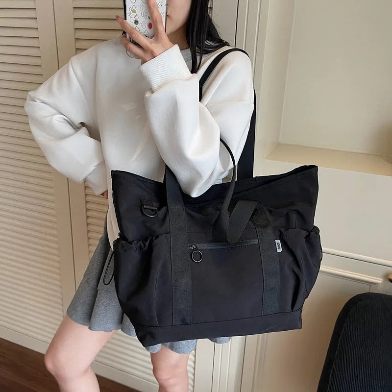 Women's Oxford travel bag in grey with 36-55L capacity and letter pattern