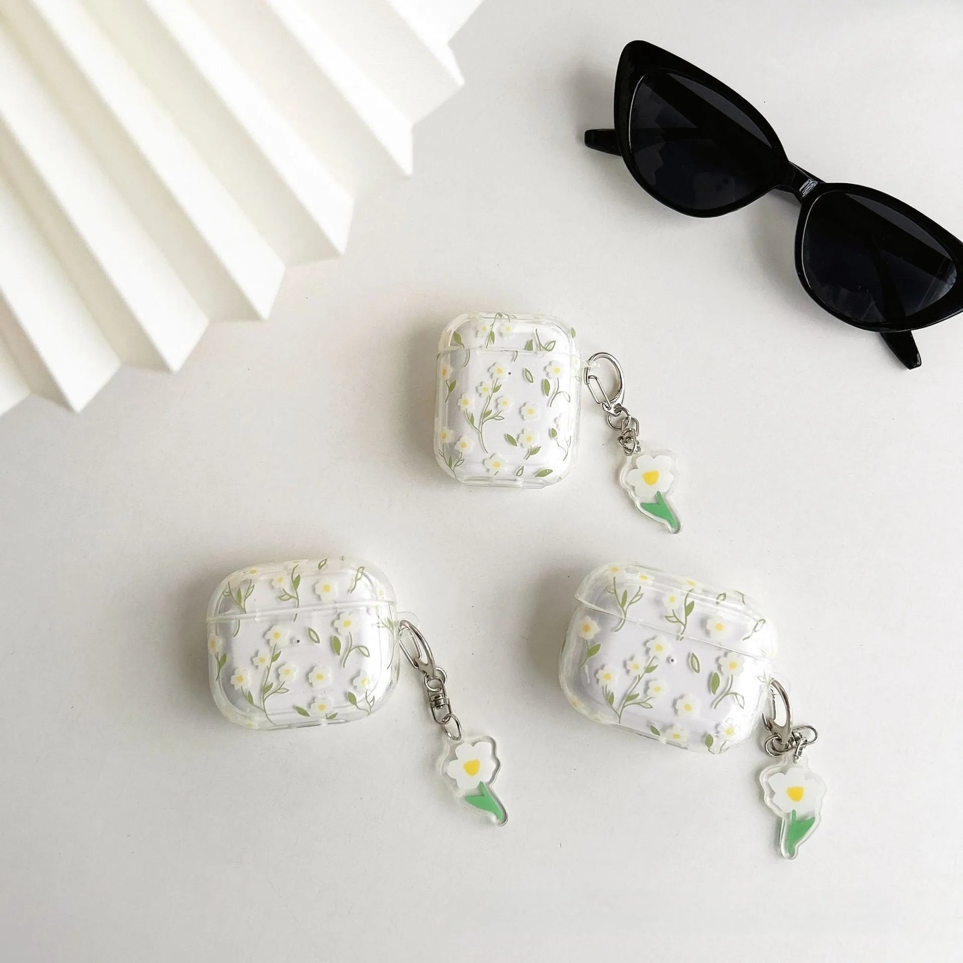 Clear TPU AirPods protective case cover with white floral design on transparent background