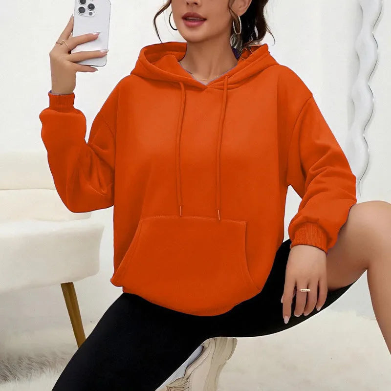 Loose fit women's drawstring hoodie in a choice of multiple colours on a hanger.