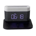 White wireless charging bedside lamp with digital alarm clock display on nightstand