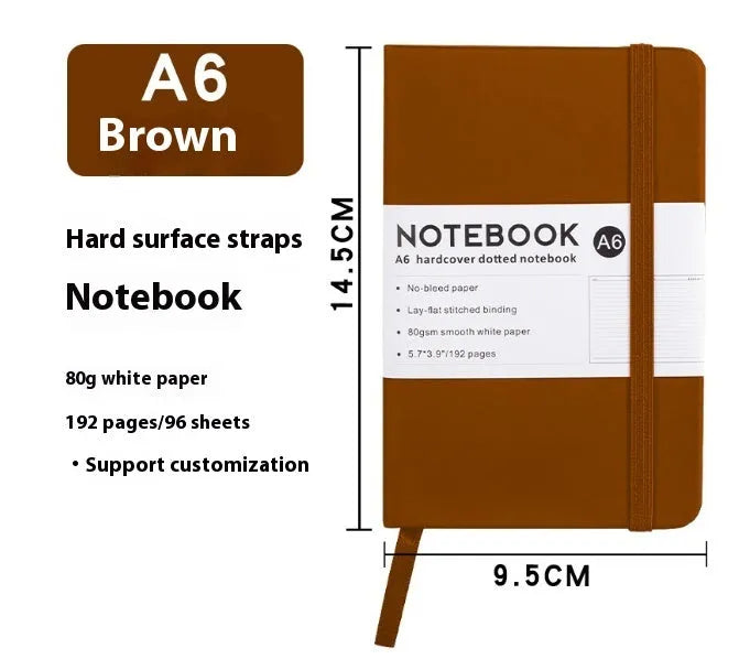 A5 size notebook with soft skin-feel PU leather cover and strap closure, open to show horizontal lined pages.