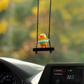 Colourful plastic cartoon duck car hanging ornament on a rear-view mirror.