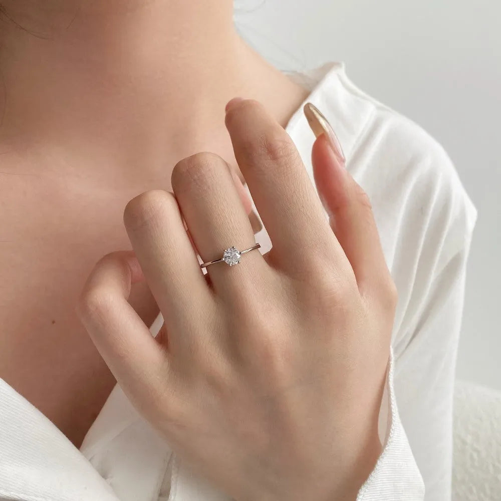Sterling silver adjustable ring with round zircon in six-claw setting, open mouth band, geometric design