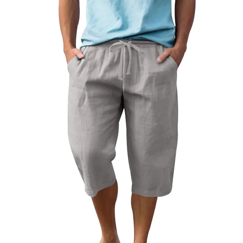 Men's solid colour linen shorts with a drawstring waist shown in a light blue shade.