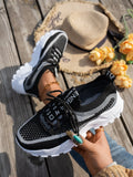 Women's Flyknit mesh lace-up sneakers in grey and white colour combination on a flat rubber sole.