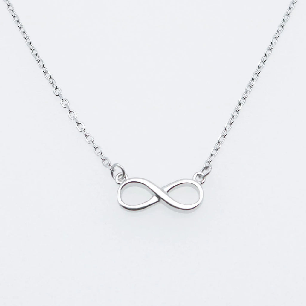 925 silver through-the-body pendant necklace with adjustable chain in platinum finish on collarbone