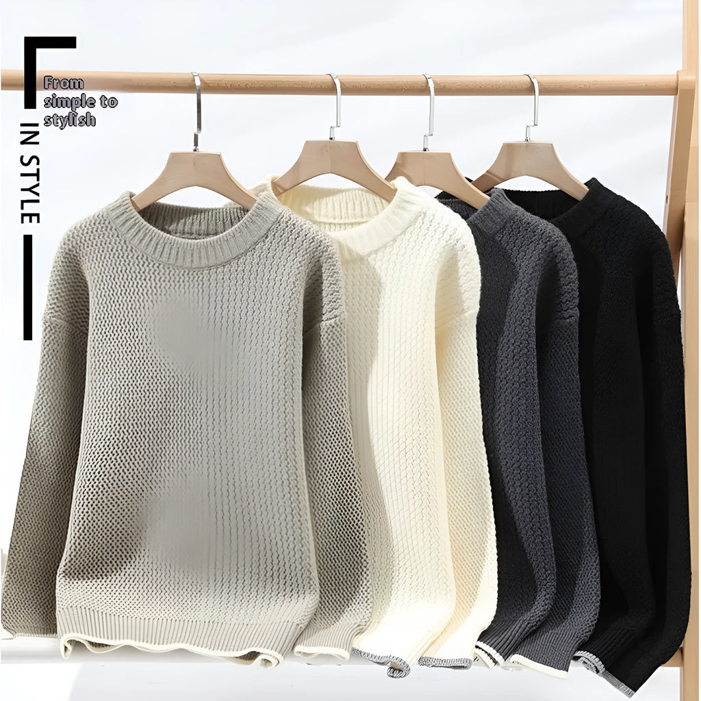 A man wearing a grey loose-fitting round neck casual pullover sweater.