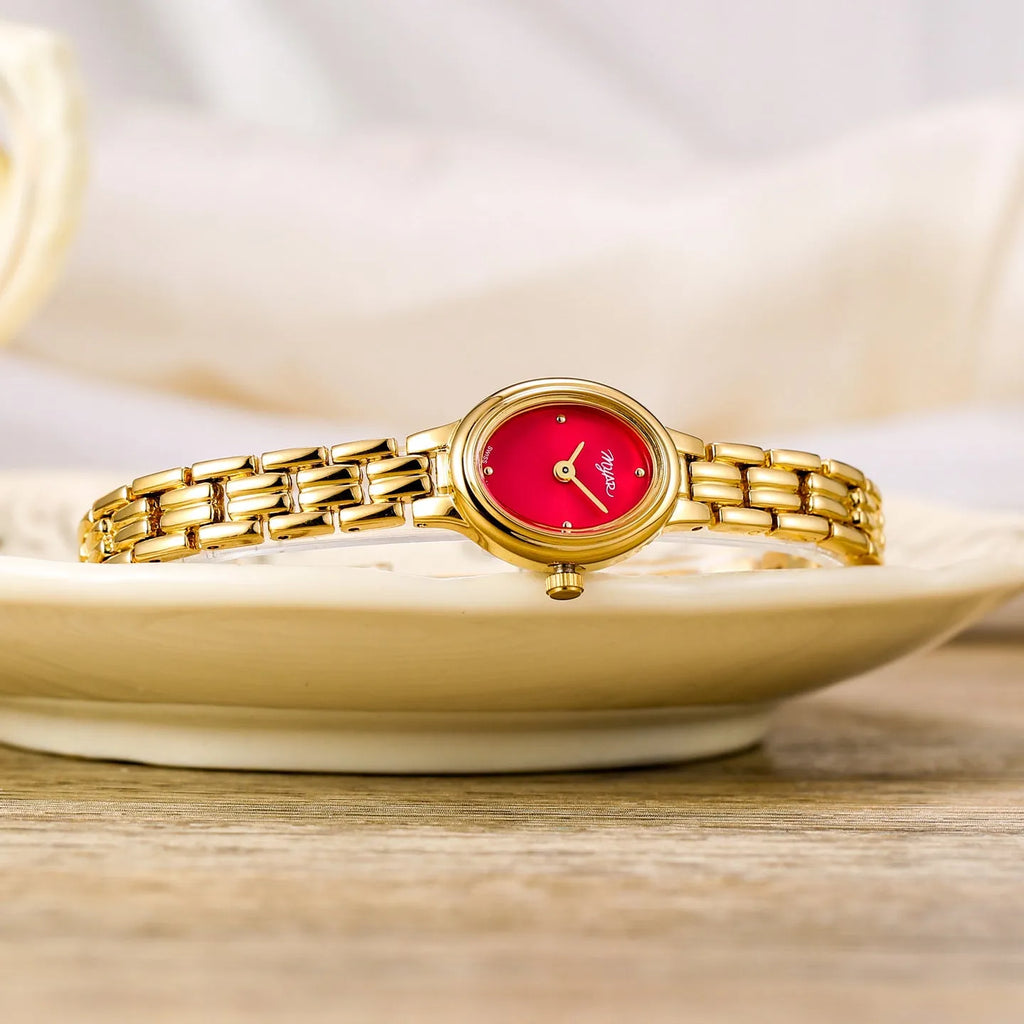 Oval mini women's vintage quartz watch with gold alloy case, white dial, and jewellery buckle