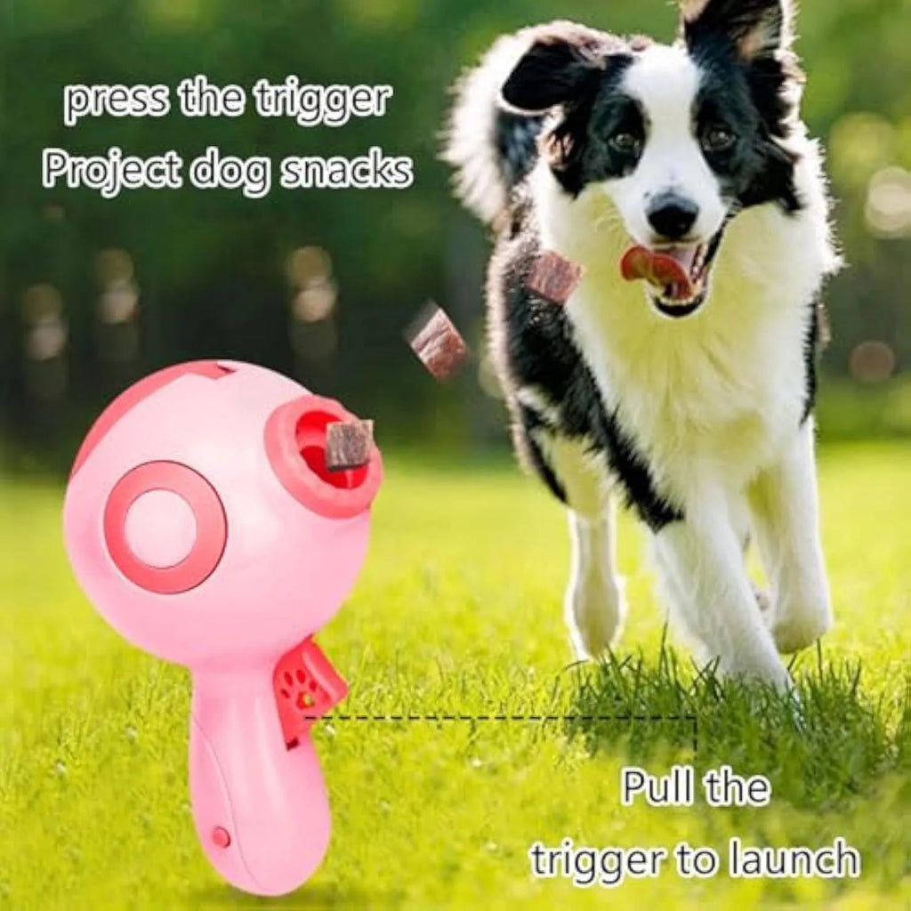 Green, orange, and pink manual dog treat launcher toy for interactive play and slow feeding.