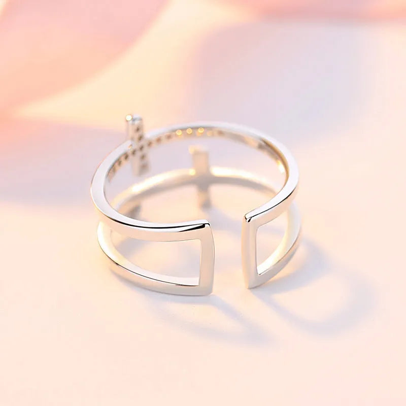 Adjustable copper ring with sterling silver inlay and white gold finish, featuring a zircon stone.