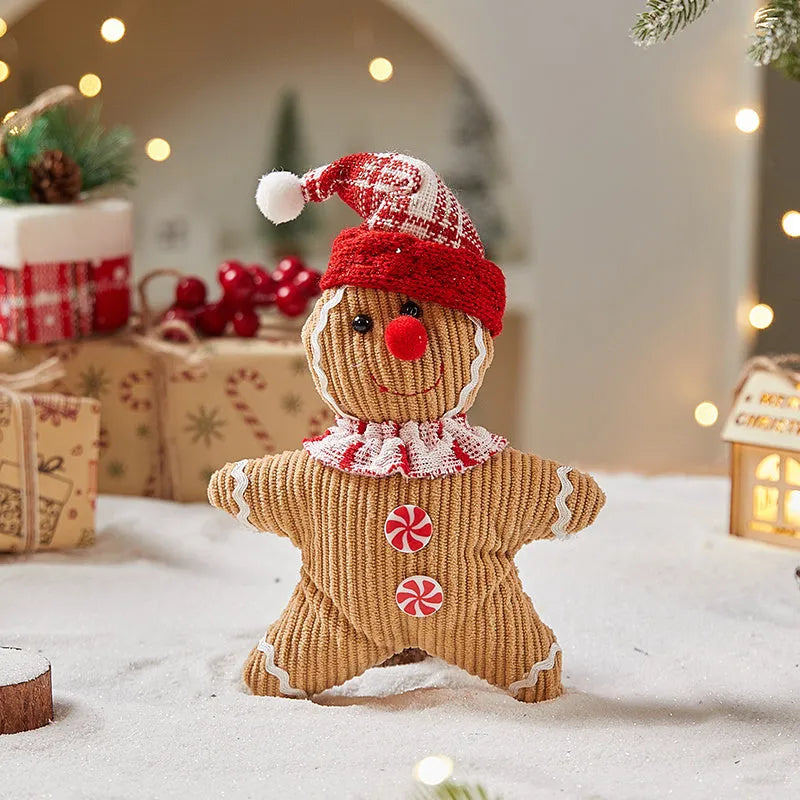 Cloth gingerbread man Christmas ornament with red hat hanging on festive branch
