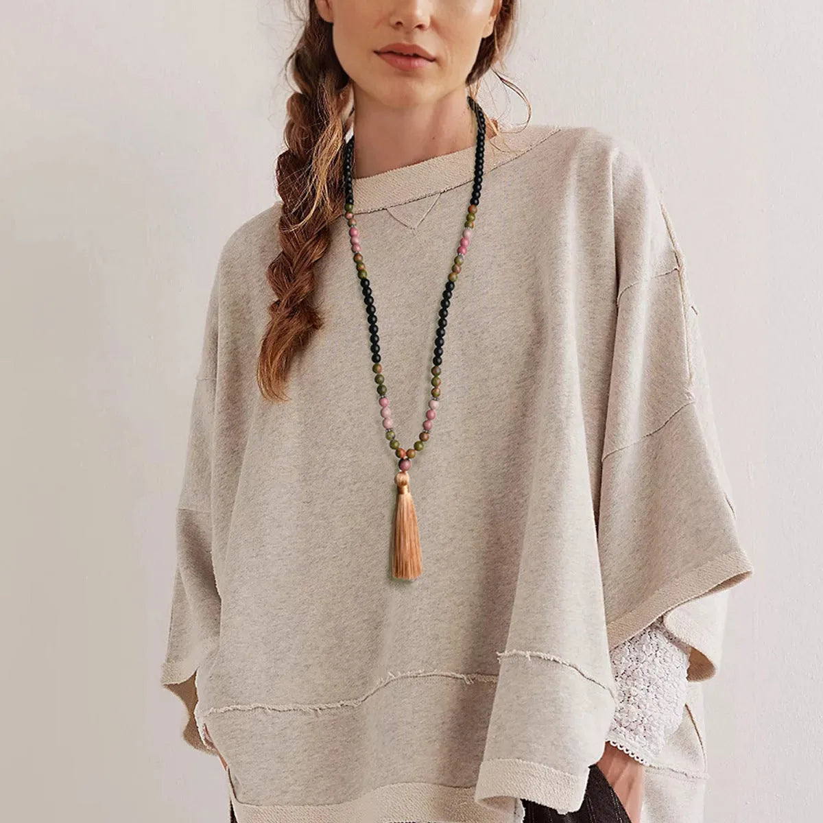 Long 108-bead natural stone necklace with a geometric tassel pendant in bohemian style.