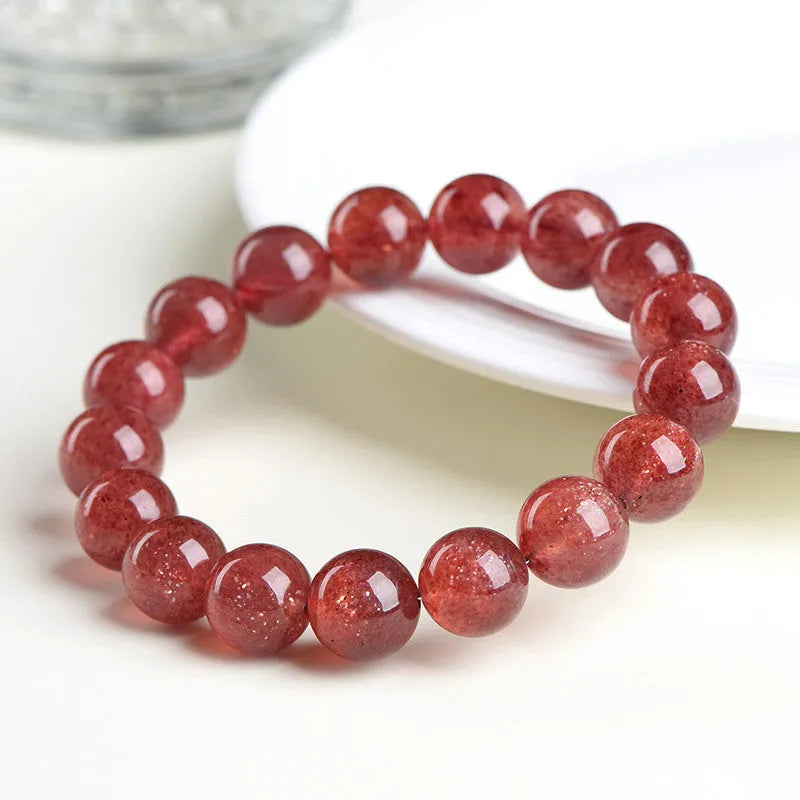 Geometric bead strawberry quartz bracelet in Starlight colour on a wrist, showing size options.