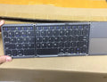 Ultra-thin tri-fold folding Bluetooth keyboard with touchpad in black, folded and spread open