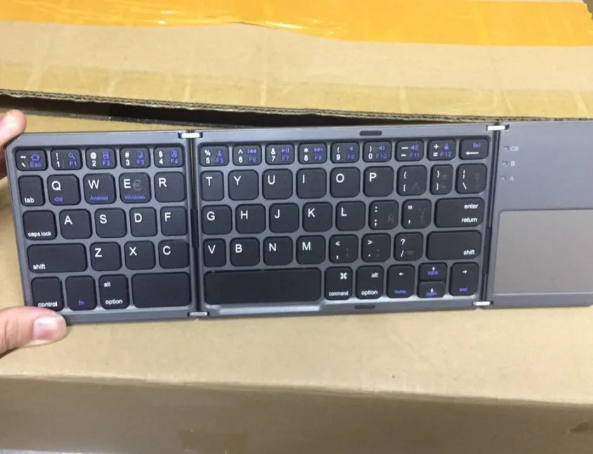Ultra-thin tri-fold folding Bluetooth keyboard with touchpad in black, folded and spread open