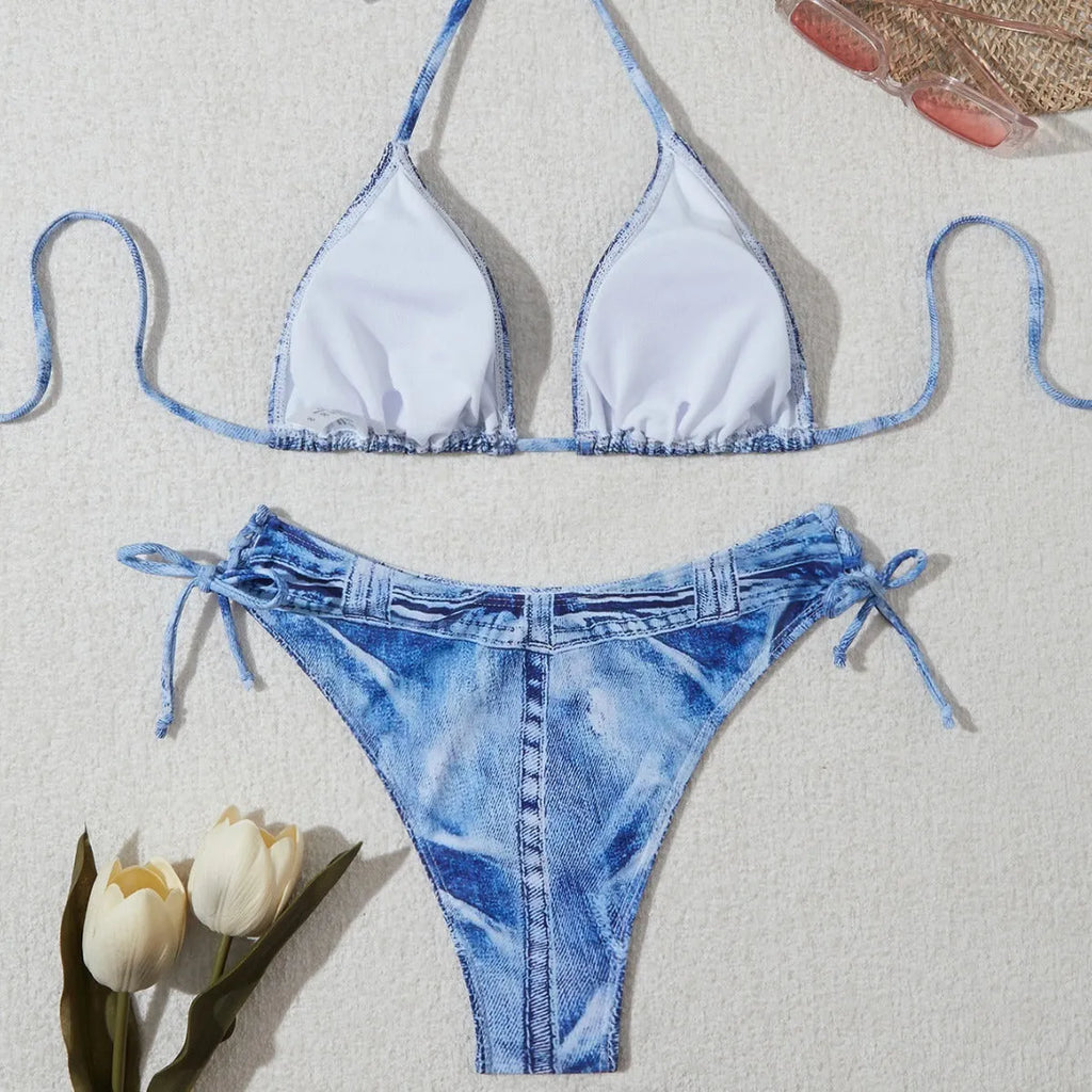 Women's denim blue printed bikini set with adjustable straps on a mannequin.