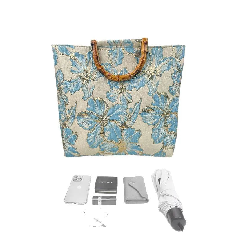 Light blue women's canvas bag with bronzing flower detail and double shoulder straps