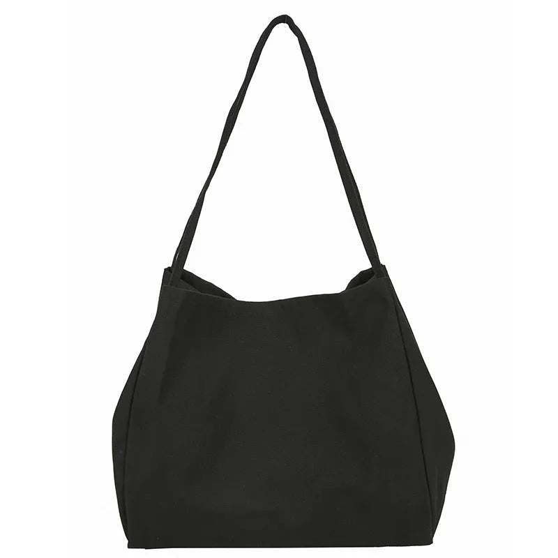 Women's solid colour canvas handbag showing horizontal square shape and double shoulder straps