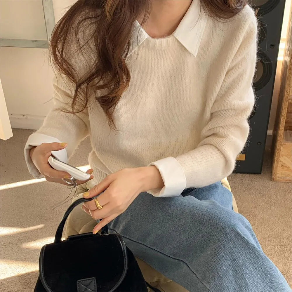 Women's loose-fit knit top with contrast lapels in navy blue, showing front design.