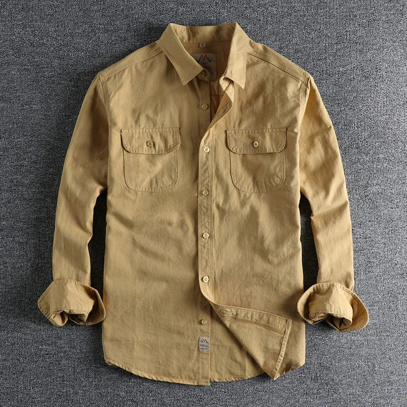 Men's light blue cotton long sleeve shirt with a regular fit and cardigan style on a hanger.