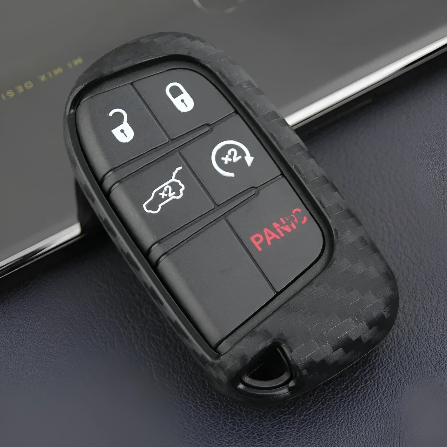 Black silicone car key case with carbon fibre pattern for Dodge, Chrysler, Fiat remote, shown with buckle option.