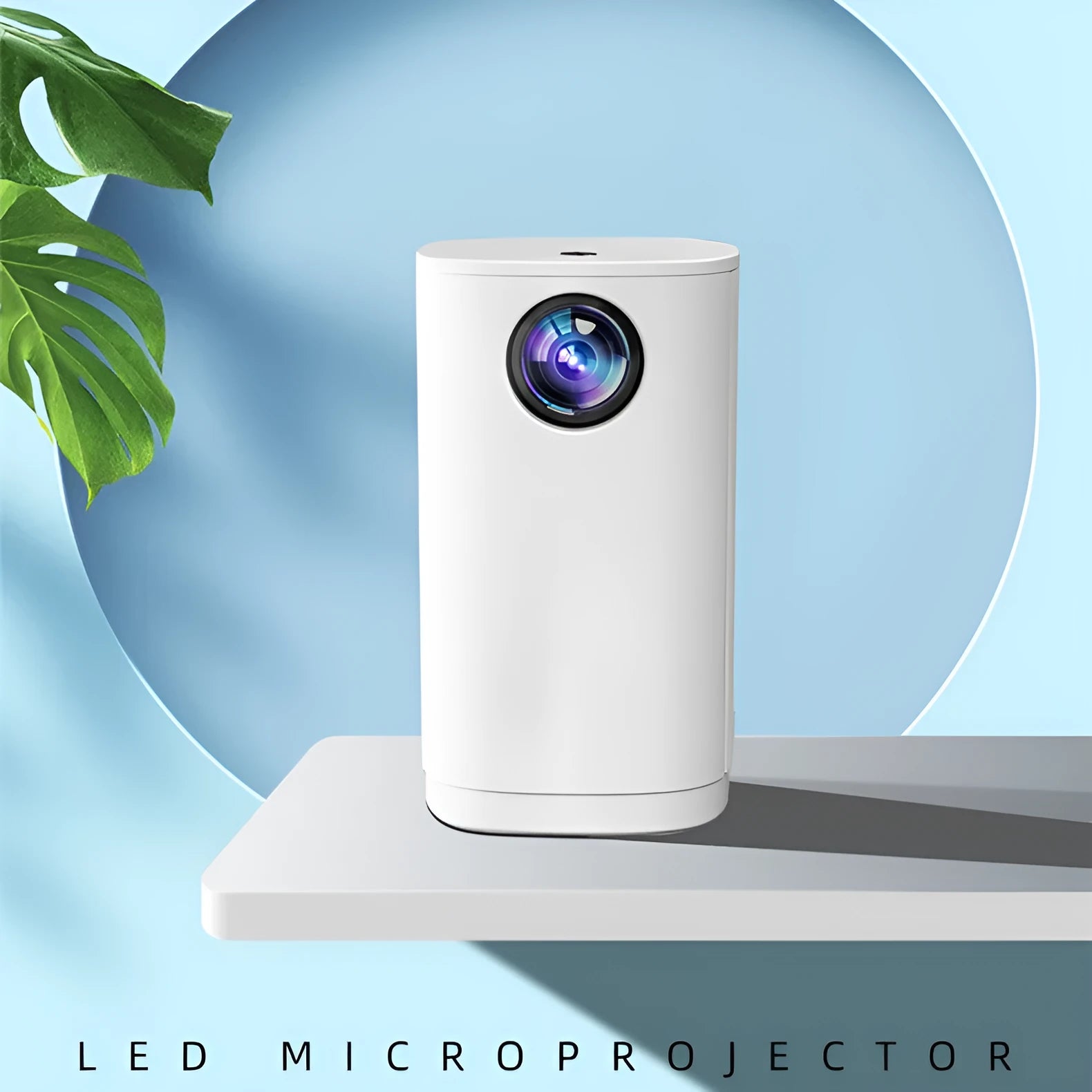 Blue mini projector with remote control on table showing movie projection on wall