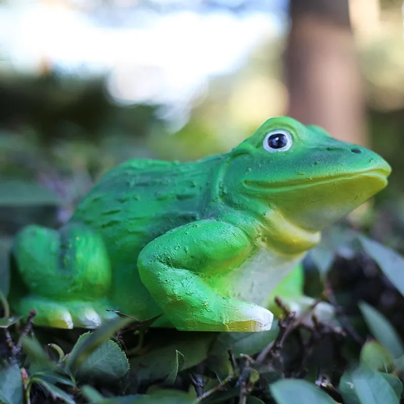 Resin solar lamp in turtle shape sitting on grass with soft LED glow at dusk