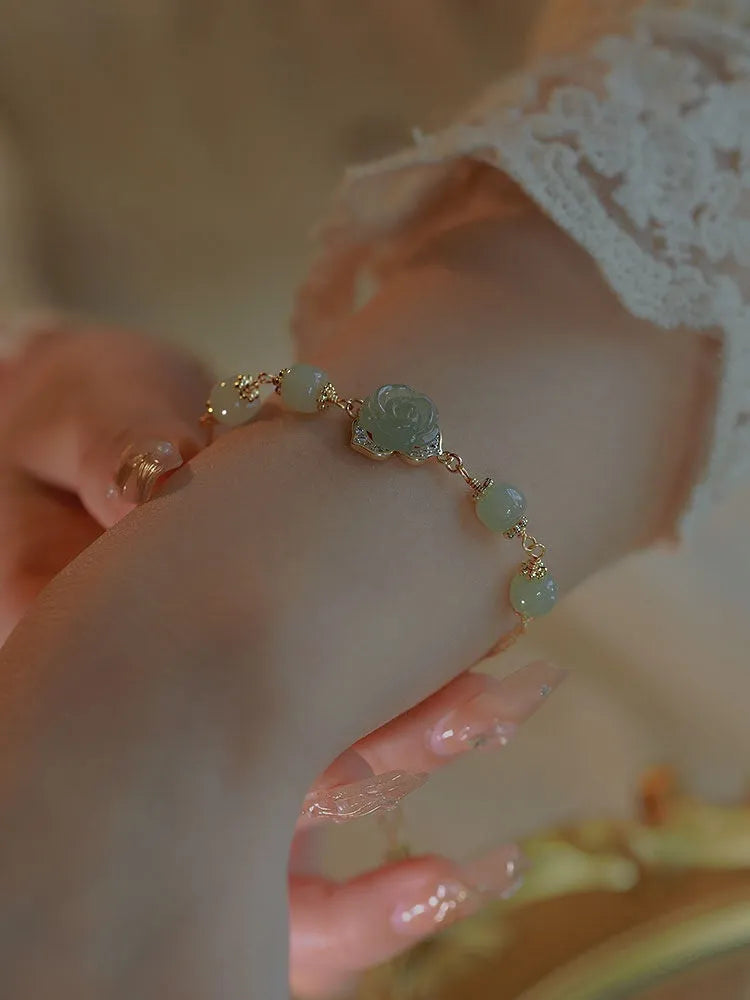 Women's jade bracelet with rose floral design and 14K gold gilding in Hetian Jade Rose colour.