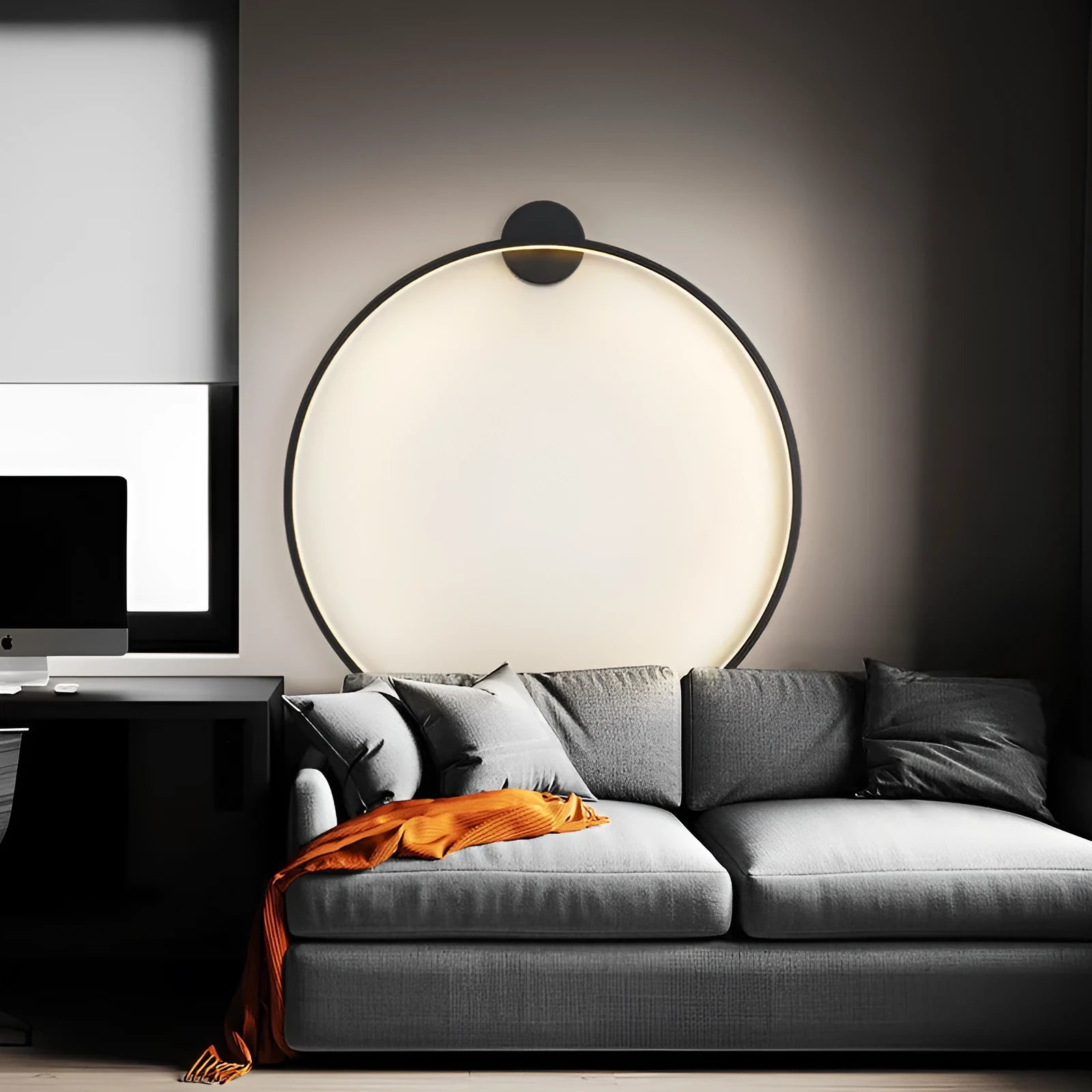 Minimalist black ring wall lamp with acrylic shade mounted on a bedroom wall