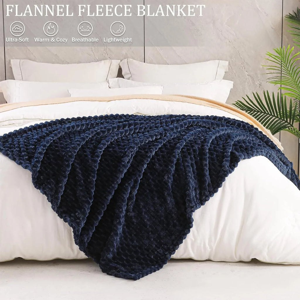 Soft camel-coloured plaid children's blanket folded on a wooden chair.